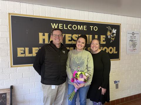 Cayce Ledford has been named as Hayesville Elementary School Teacher of the Year. Ledford, in center, receives flowers from Clay Schools Superintendent Dale Cole and HES Principal Melissa Godfrey.