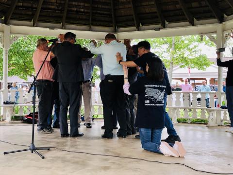 Jin Woo-Kim (right) shares prayer with local pastors, assisted by Min Sun-Park and the over 100 in attendance on the square in Hayesville during the Prayers for America gathering on Sunday. Prayer teams visited Clay County during their Prayers for America journey. During their stay here prayers were shared in Clay, Cherokee and Graham counties and the Eastern Band of Cherokee before moving on to Charlotte, N.C.