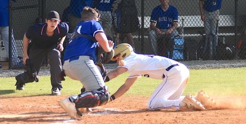 Gary Corsair • Clay County Progress Hayesville outfielder Logan Caldwell reaches for the plate as Hiwassee Dam catcher Trenten Beavers tries to glove the baseball. 