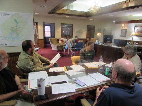 Joanna Atkisson, of the Building Outdoor Communities Program, briefs Town Council members on the need for a community resolution.