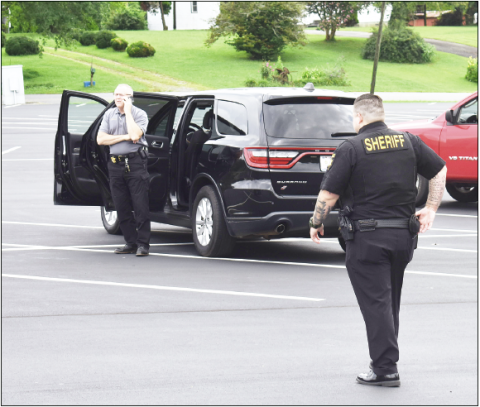 Becky Long • Clay County Progress Sheriff Mark Buchanan coordinates through his cellphone from the parking lot of First Free Will Baptist Church/Carolina Christian Academy after the pastor received a politically motivated call. No one was threatened or injured in the incident, but the sheriff’s office took precautions and manned the site while tracking down the caller.