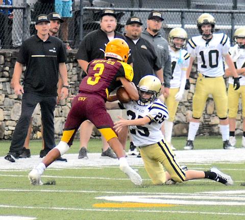Gary Corsair • Clay County Progress Hayesville's Braiden Tanner, No. 25, puts the clamps on a Cherokee ball carrier.