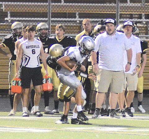 Gary Corsair • Clay County Progress Johan Webb, No. 2, hears the roar of approval from his sideline as he wrestles a Black Knight out of bounds.