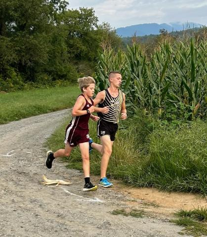 Micah Moss rounds the corner and heads to the finish line for a 6th place finish to lead the HMS boys team.