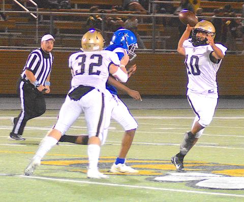 Gary Corsair • Clay County Progress Hayesville quarterback Cole Vining, No. 10, rolls out to pass as Dawson Devane, No. 32, provides protection.