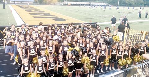 Youth cheerleaders and football players