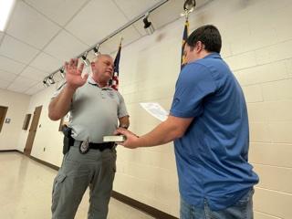 Randy Foster/editor@cherokeescout.com Andrews Interim Police Chief David Southards, left, is administered the oath of office by Town Clerk Ethan McCubbin at the facilities building Friday.