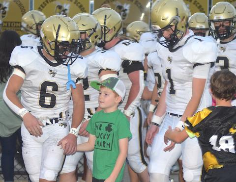 Gary Corsair • Clay County Progress Miracle boy Dallas Wilson walks with his friends Tre Graves, No. 6 and Peyton Mcgaha, No. 1, as the varsity Hayesville Yellow Jackets take the field Friday night.