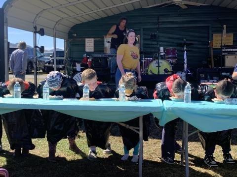 Hillary Bond keeps the pie-eating contest moving along while contestants put in their best times finishing the fall favorite dessert of pumpkin pie. The contest is among many activities for children available at the Clay County Chamber of Commerce Punkin Chunkin. An estimated 7,0000 people came to watch pumpkins fly and enjoy an array of food and crafts from vendors during the two-day annual event in Brasstown..