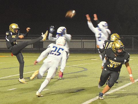 Gary Corsair • Clay County Progress Hayesville freshman Lance Coker, No. 12, keeps his cool as he kicks the ball over three Christ The King defenders. Coker boomed two punts for a total of 72 yards in his varsity debut as a punter.