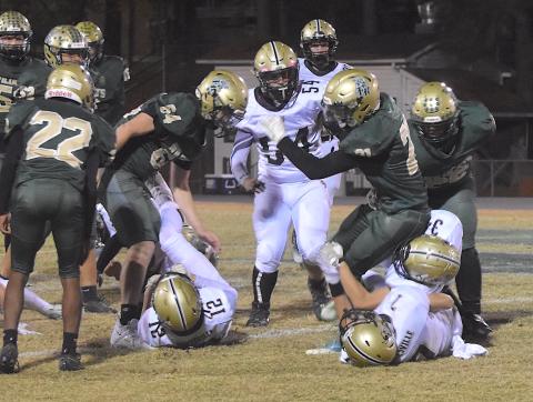 Gary Corsair • Clay County Progress Hayesville defenders Eli Jack, No. 7, and Maverick Imlay, No. 34, drop an Eastern Randolph back for a loss as Yellow Jacket Nathaniel Dockery, No. 54, prepares to pounce.