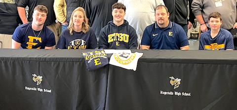 Hayesville two-way football standout Taylor McClure is all smiles after signing a letter of intent to play Division 1 football at East Tennessee State University in Johnson City, Tenn. Taylor, is flanked by parents Keisha and Chad McClure and joined by older brother Blake and younger brother Caden. Taylor is one of nine incoming freshman signees at ETSU.