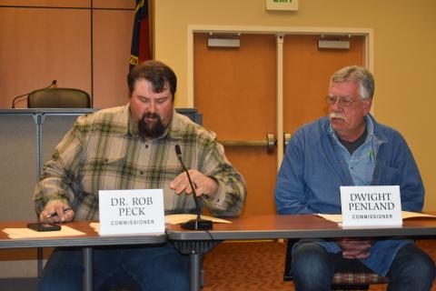 Commission Vice Chairman Randy Nichols reviews a summary of the county’s audit report as Commissioner Dwight Penland looks on during the Jan. 4 monthly meeting. Nichols credited county employees for helping the county receive high marks on its audit.