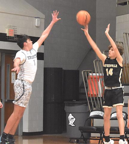 Gary Corsair • Clay County Progress Brady Reynolds, No. 14, punishes Robbinsville with a three-point bomb from the corner.
