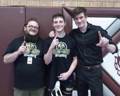 From left: Coach James Denton, Brett Hanna and Coach Jacob Handy after Hanna wins the Smoky Mountain Conference.