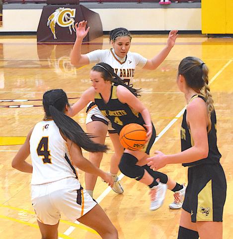 A pair of Cherokee defenders try to corral Hayesville dynamite Breanna Abrams, No. 4, as the Lady Jackets guard advances the ball past the time line as teammate Ava Shook looks on.
