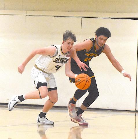 Hayesville's Luke Lee, No. 4, starts up court as Murphy's Dominick Rummel gives chase.