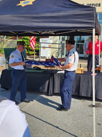 From left, Honor Guard Members Mitchell Shields and Phil Cantley fold the flag during a memorial ceremony at the Clay County Sheriff's Office.
