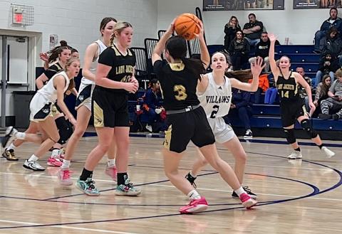 Photo by Beth Chandler Briley Clampitt, No. 14, calls for the ball as Brooke Graves, No. 40, comes up to set a screen as Jasmine Brooks, No. 3, quarterbacks the Hayesville offense against Bishop McGuinness.