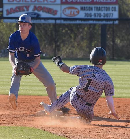Gary Corsair • Clay County Progress Hayesville speedster Michael Mauney, No. 1, slides into second base ahead of the throw from the Hiwassee Dam catcher.