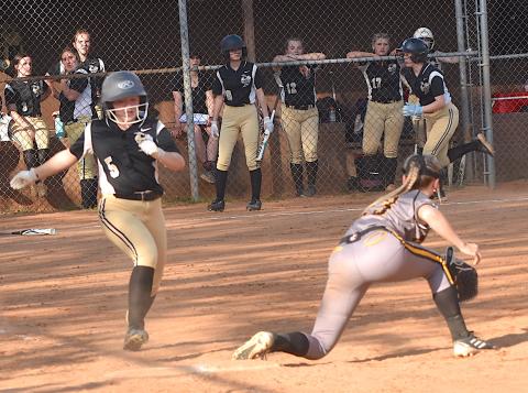 Gary Corsair • Clay County Progress Hayesville's Callie Long, No. 5, legs out a bunt as teammate Raelynn Taylor motors down the third baseline to score the Lady Jackets' fourth run.