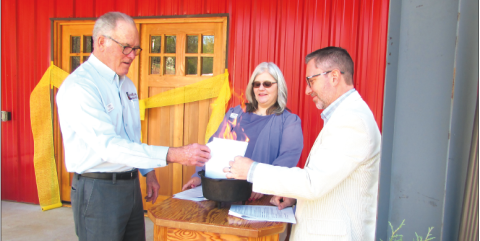 Lorraine Bennett • Clay County Progress Hinton Center, from left, Chief Financial Officer John Nicholas, President and CEO Dr. Jacqueline Gottlieb and Board of Directors Chairman Rev. Dr. Tim Moore burn the building’s note.
