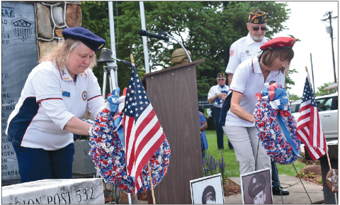 Becky Long • Clay County Progress American Legion Auxiliary member Charlotte Tilley and VFW Auxiliary member Linda Bond conduct the ceremonial placing of the wreaths on the Hayesville monument during Monday’s Memorial Day service.