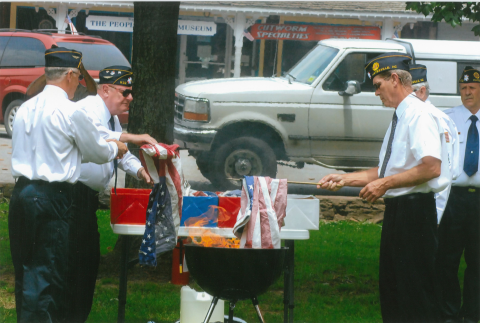 Veterans dispose of the American flag in a previous flag retirement service on the Hayesville town square, among the participants are from left, Tommy Hooper, Jack Greve and Carl Maxwell