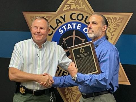 Clay County Sheriff Mark Buchanan presents Ed Figueroa with the Appreciation for Exemplary Service award.