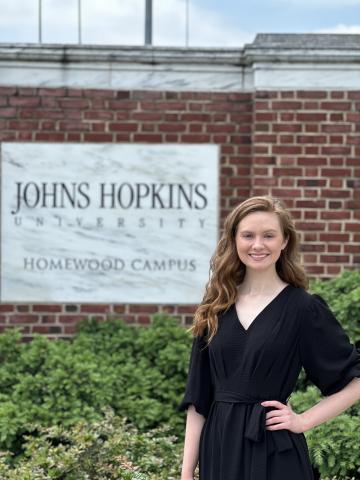 Photo by Connor Vernachio A jubilant Brianna Ross stands at the entrance of the Johns Hopkins University campus in Baltimore after receiving a Masters Degree in May 2024.