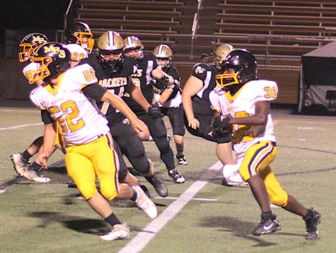 Photo courtesy Cherokee Scout Hayesville lineman Rayland Martinez, No. 74, leads the defensive line in pursuit of Murphy's Way Herron, No. 32.