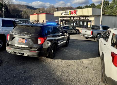Randy Foster • Cherokee Scout Cherokee County sheriff's deputies and Murphy Police Department officers at a drug raid at Tobacco & Vape store off Andrews Road in Murphy on Friday afternoon. Two people were taken into  custody during the raid in Murphy, with one released and the other,  Wyle Radwan Alsalme, 21, of 1508 Andrews Road, Murphy, Alsalme  charged with possession of a schedule I controlled substance and released in lieu of $10,000 bond. The raid was part of a three-county operation in Clay, Cheroke