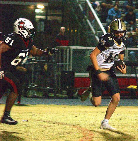 Gary Corsair • Clay County Progress Hayesville quarterback Lance Coker, No. 12, abandons plans to pass and turns on the afterburners to elude an Andrews pursuer.