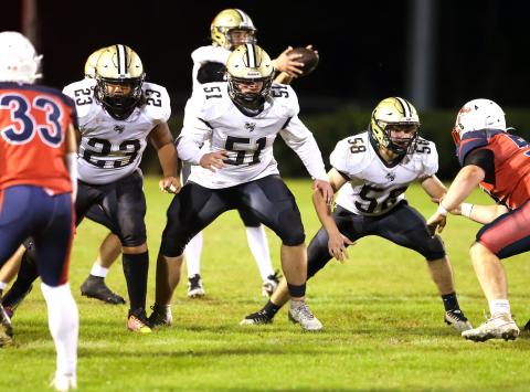 Photo by Marc Lancaster Hayesville lineman E.J. Mapasua, No. 23, Brendon Collins, No. 51, and E.J. Abrams, No. 58, protect quarterback Tate Roberts with the skill of Secret Service bodyguards.