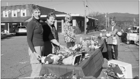 Photo by Sandy Zimmerman From left, Shoppers Carlene Dockery, Cheryl Sullivan and Paula Culbreth viewed holiday items available during the HHI sidewalk sale with volunteer Carleen Brock. Proceeds from the event and holiday concert will benefi t Hurricane Relief fund.