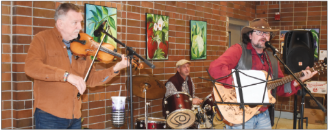 Becky Long • Clay County Progress Attendees to Saturday’s holiday luncheon enjoyed the southern sounds of Big Ol Southern Grin featuring, from left, John Andrews on fi ddle, Joey Buckner on drums and Josh McConnell on guitar. The band plays local private and public venues. They can be reached at 828-342-8444. They describe their repertoire as outlaw country. The band’s name was born from a lyric in the Lynyrd Skynyrd hit “Workin’ for the MCA.”