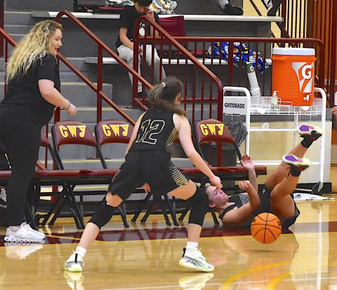 Gary Corsair • Clay County Progress Aaliyah Jackson tumbles across the floor after saving the basketball from going out of bounds by slapping it to Olivia Free, No. 12.