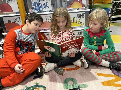 Deby Jo Ferguson • Clay County Progress Sharing a book with friends is always fun on pajama day. From left is Isaiah Cline, Kaytney and Arthur Diesz.