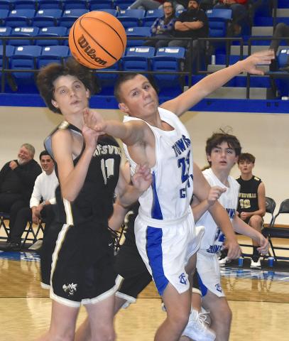 Gary Corsair • Clay County Progress Hayesville's Daemien Soto, No. 11, battles a Towns County player for the ball in JV action Friday.