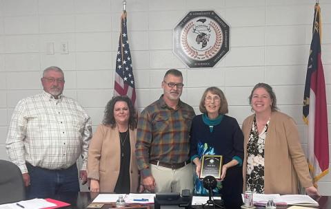 Clay County Schools Reba Beck is honored for service to the community and schools on Monday, Nov. 25 by Clay County Schools Board of Education members, from left, Danny Jones, Kelly Crawford, Dr. Jason Shook, Beck and Superintendent Melissa Godfrey.