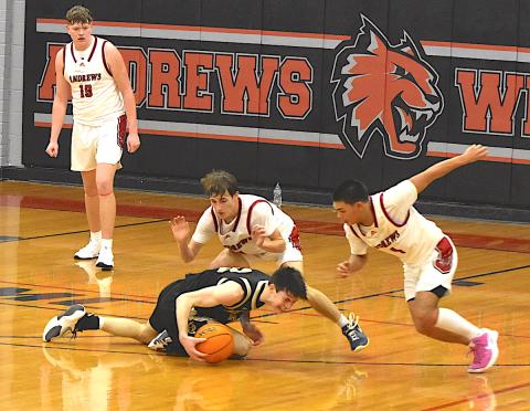 Gary Corsair • Clay County Progress Hayesville's hopes of tying the score against Andrews disappeared on this play when two Wildcats converged on Slade Crouch, No. 3, wrestled the ball away from him and scored a final basket.