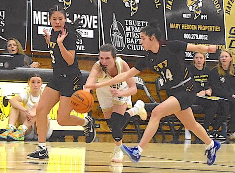 Gary Corsair • Clay County Progress Hayesville's Ava Shook, No. 2, fights to keep her balance as she splits Cherokee's oppressive full-court press.