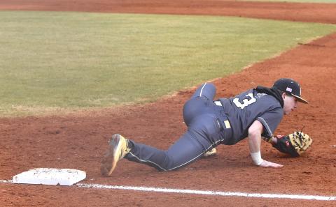 Gary Corsair • Clay County Progress Hayesville first baseman Kyle Shaheen contorts his body to spear a low throw.