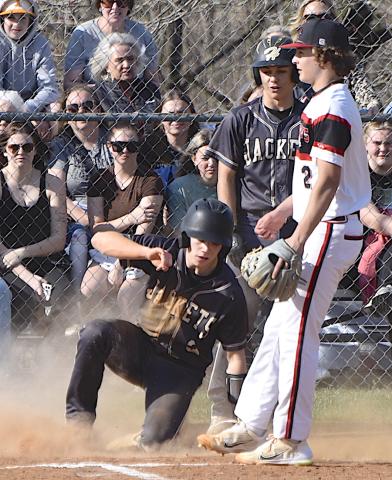 Gary Corsair • Clay County Progress Jacob Cody arrives home in a cloud of dust during Hayesville's lopsided win over Andrews.