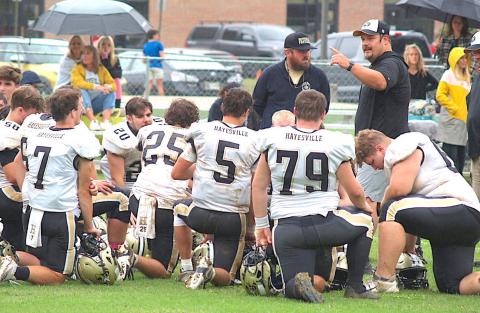 Coach Chad McClure coaching the football team.