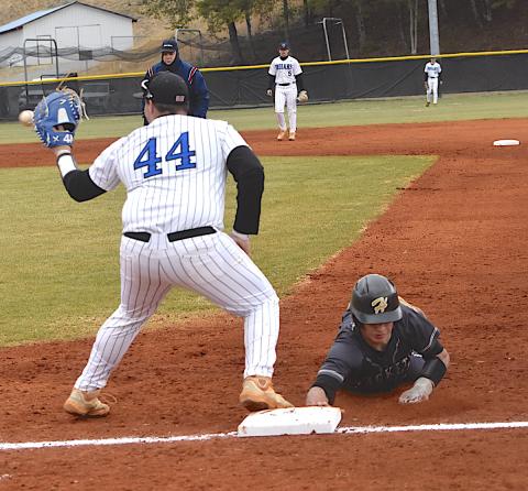 Gary Corsair • Clay County Progress Yellow Jackets shortstop Tate Roberts dives back to the bag in time during a pickoff attempt last week.