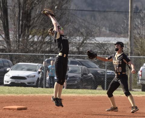 Gary Corsair • Clay County Progress Hayesville's Lillie Chastain leaps to catch a high throw during a rundown against Andrews as winning pitcher Micalynn McClure, No. 10, arrives to help nab the Wildcat base runner.