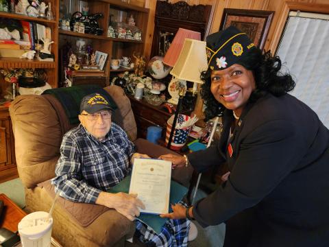 Bob Epperson receives his certificate of membership from Patricia Harris.