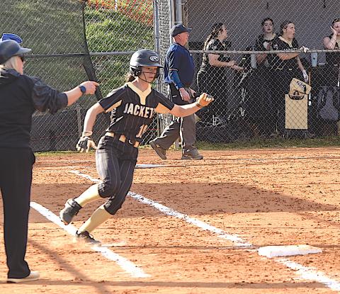 Gary Corsair • Clay County Progress Hayesville Assistant Coach Jessica McClure waves Micalynn McClure on to extra bases after the fabulous freshman slammed a pitch into the outfield.
