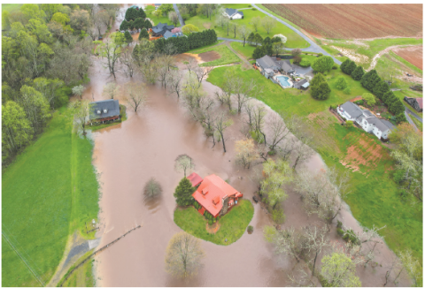 Ron Wallace Photo A home in the River Oaks community appears to stand on its own island after the creek overflowed.